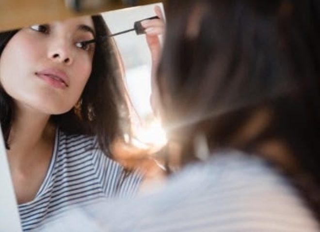 Woman applying mascara