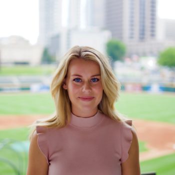 female lasik patient standing near baseball stadium